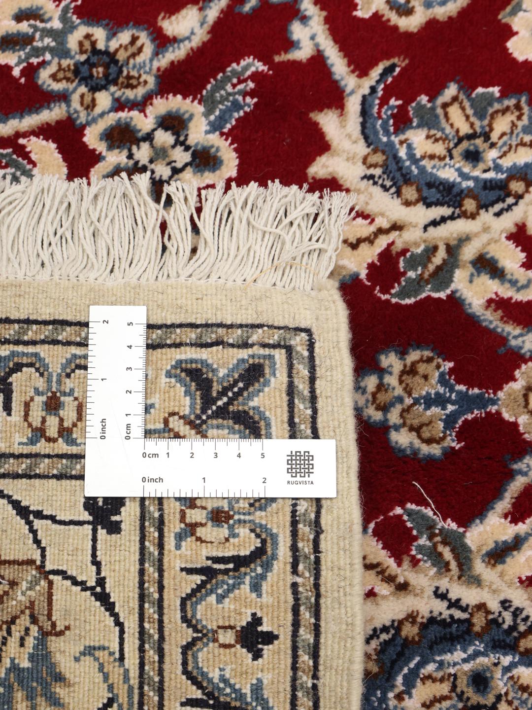 Hand-knotted Nain rug from the Middle East in deep red with floral patterns
