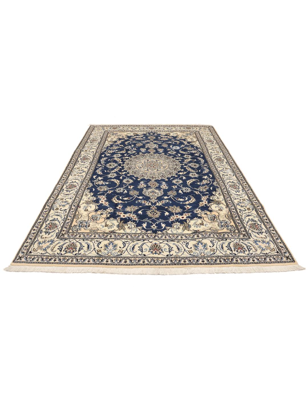 Hand-knotted Nain rug from the Middle East with a deep blue field and floral motifs