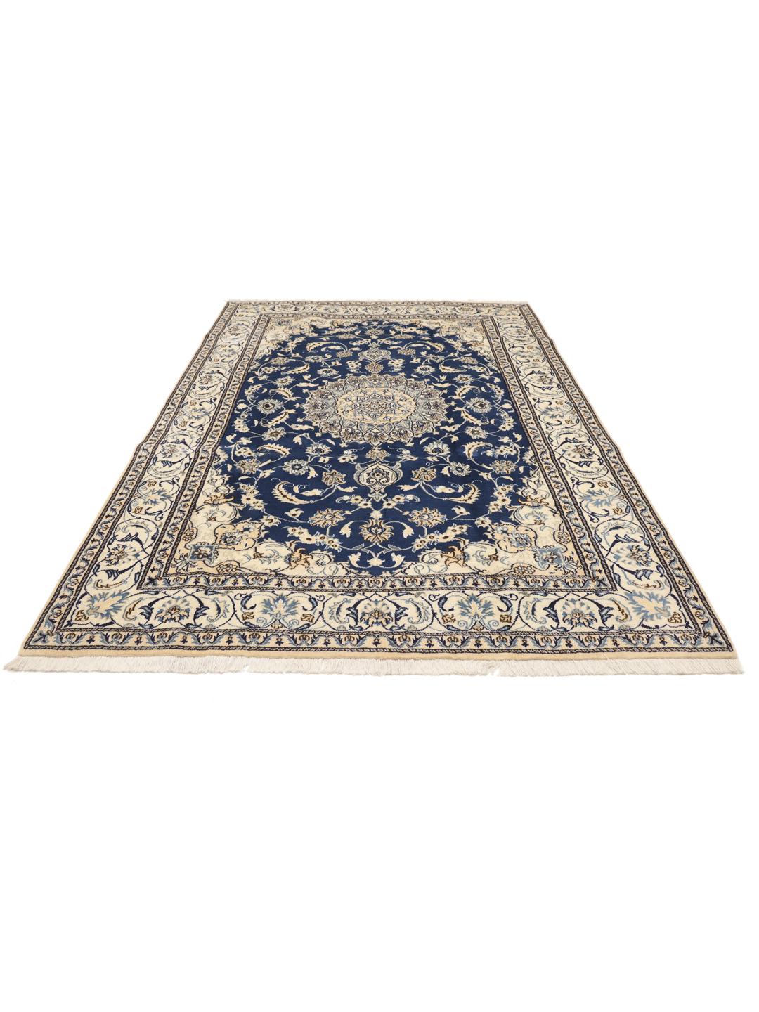 A hand-knotted Nain rug from the Middle East with a deep blue and cream floral pattern.