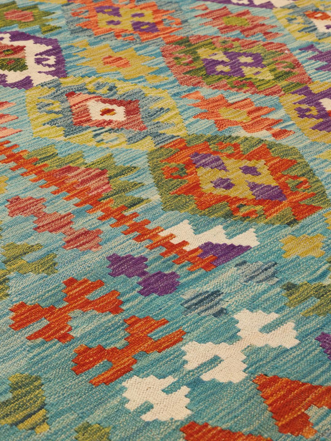 Hand-woven Afghan Kelim rug with a vibrant geometric pattern in blue and multi-coloured accents.