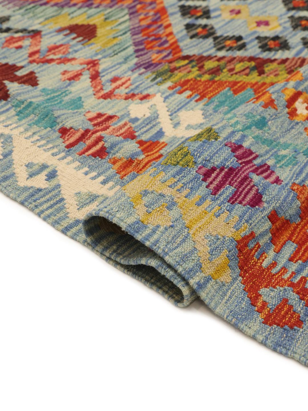 Hand-woven Kelim Afghan Old Style rug with a blue base and geometric diamond patterns.