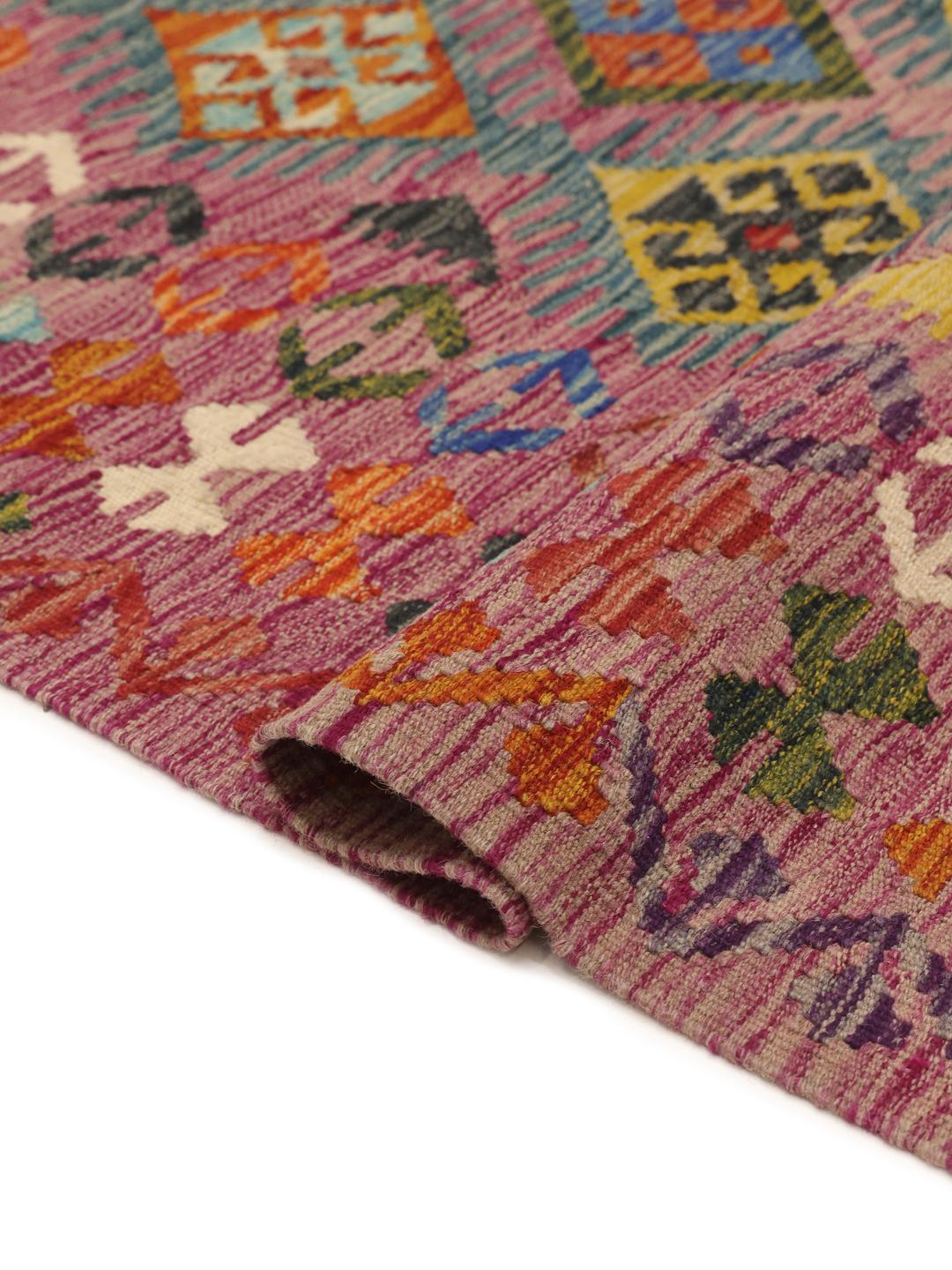 A hand-woven, one-of-a-kind Afghan kelim rug featuring a vibrant, multicoloured geometric pattern.