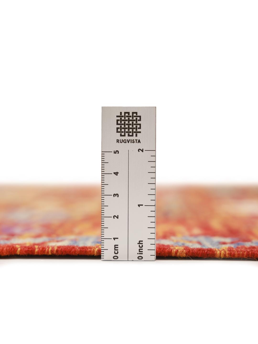 A hand-woven Afghan kelim rug featuring a vibrant red field with intricate geometric patterns.