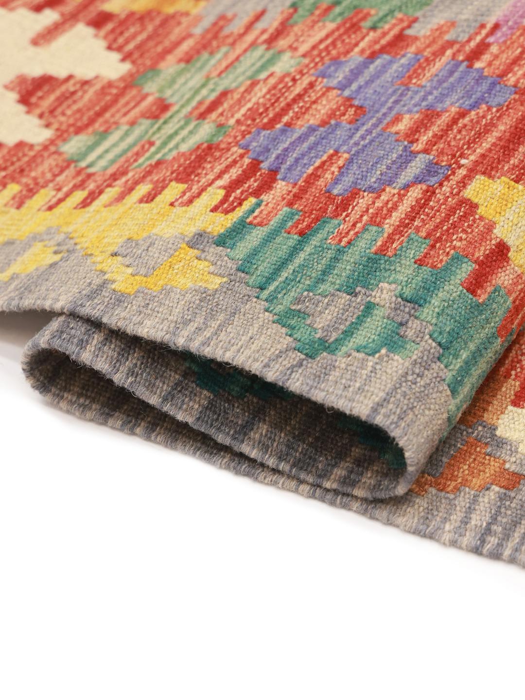 Hand-woven Afghan Kelim rug featuring a vibrant multicolor diamond pattern on a grey background