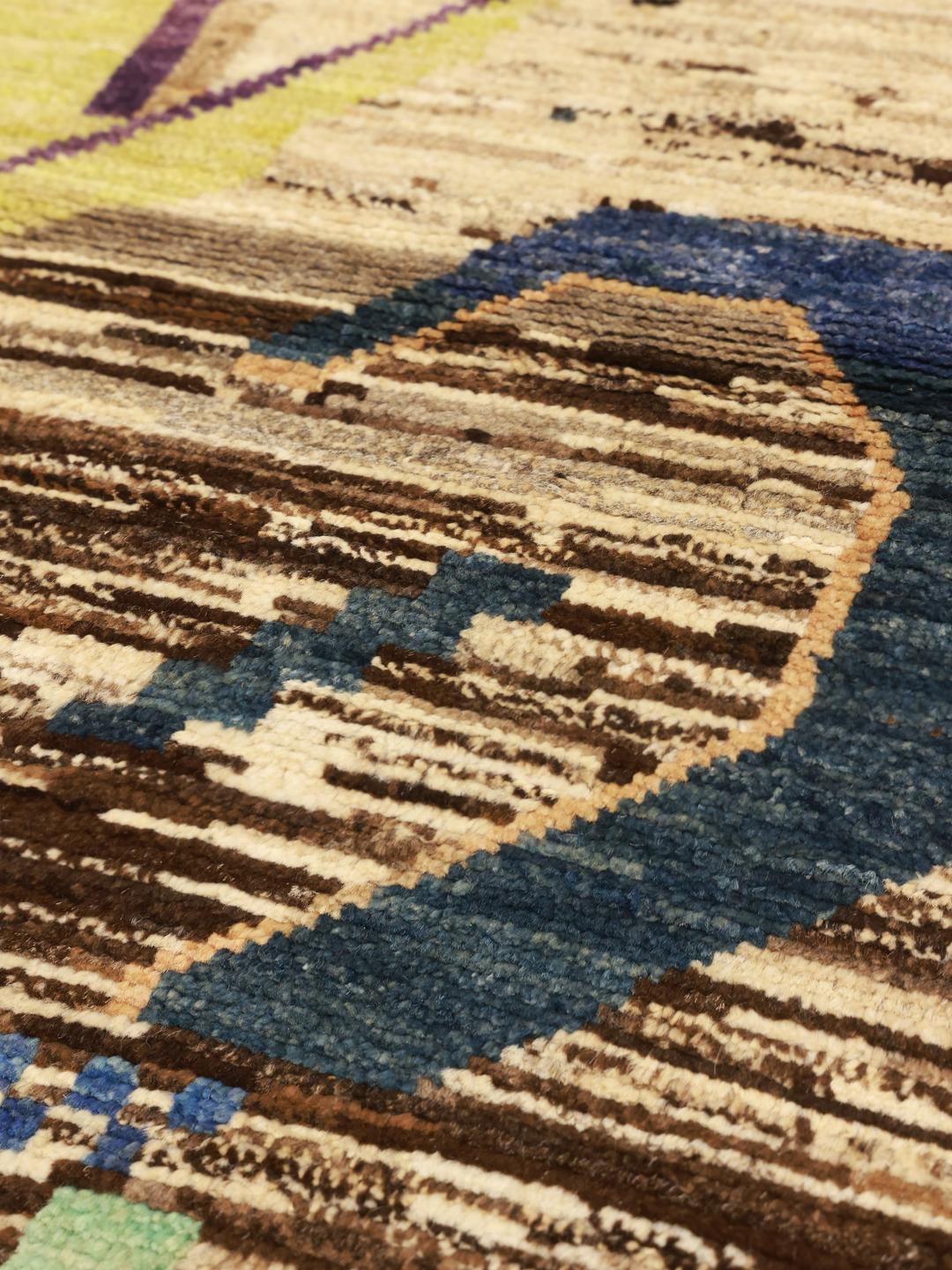 Hand-knotted Afghan rug with colourful artistic motifs on a brown background
