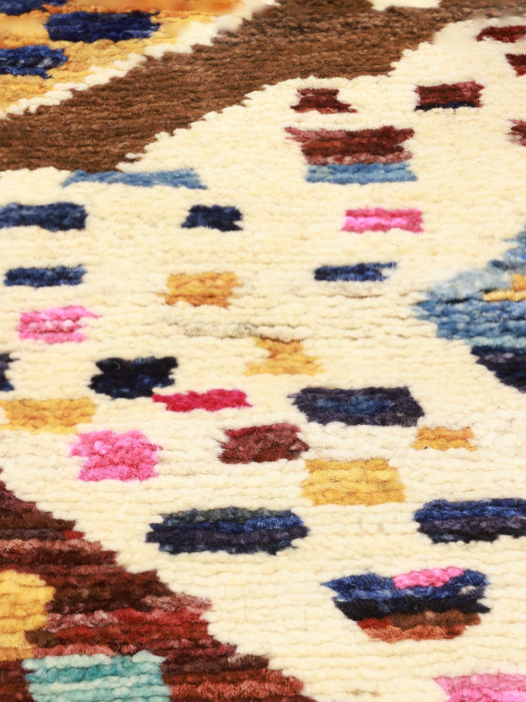 Hand-knotted Berber rug from Afghanistan with colourful diamond patterns on a brown background.
