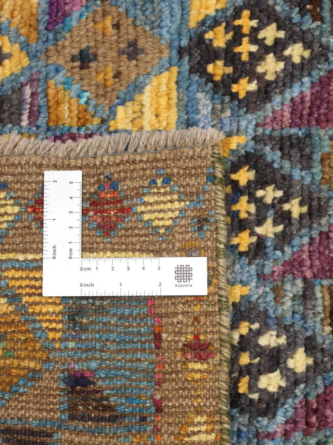 En livlig, håndknyttet løber fra Afghanistan med et farverigt geometrisk diamantmønster.