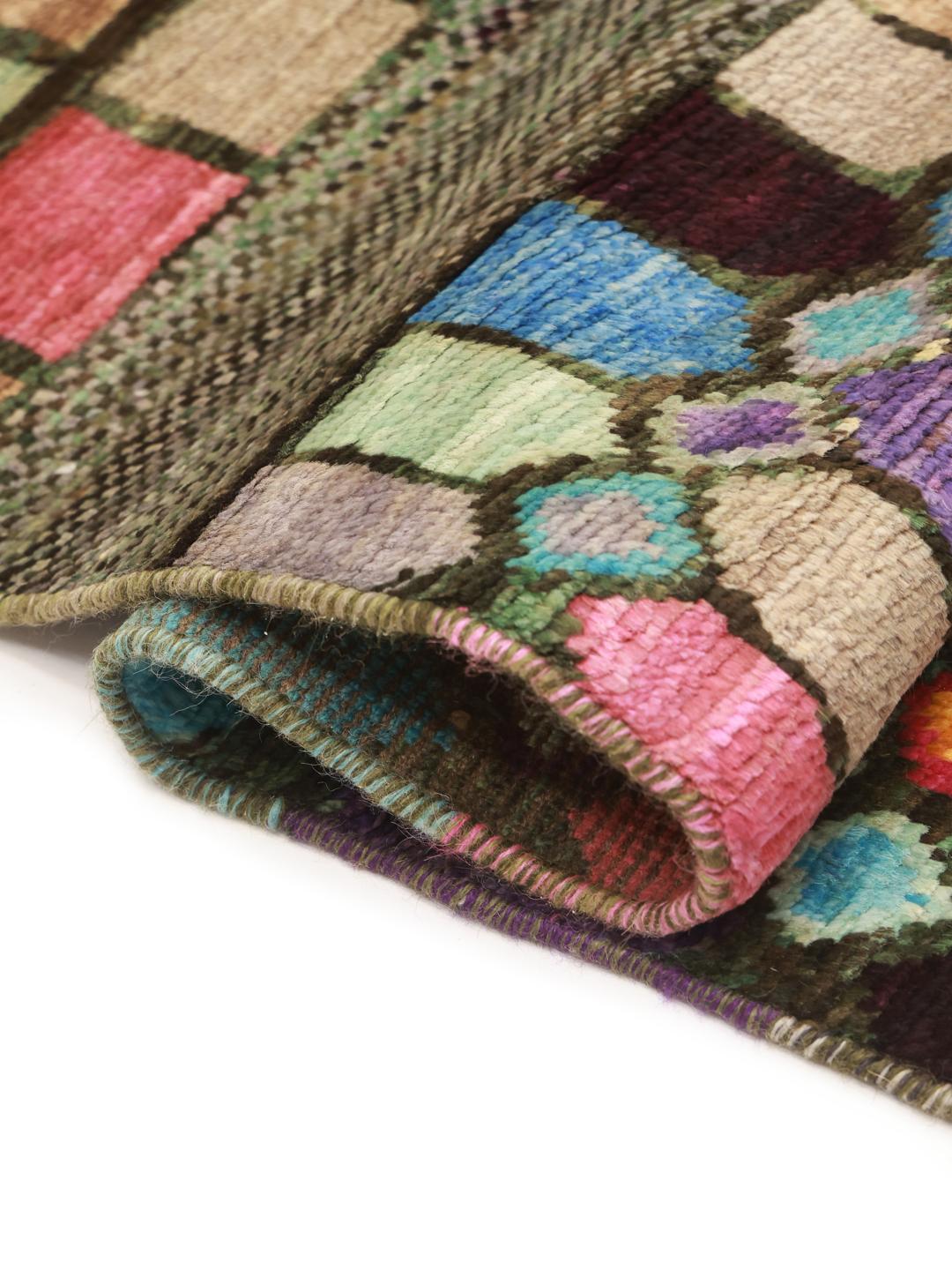 A vibrant rectangular Berber rug from Afghanistan with a colourful geometric pattern.