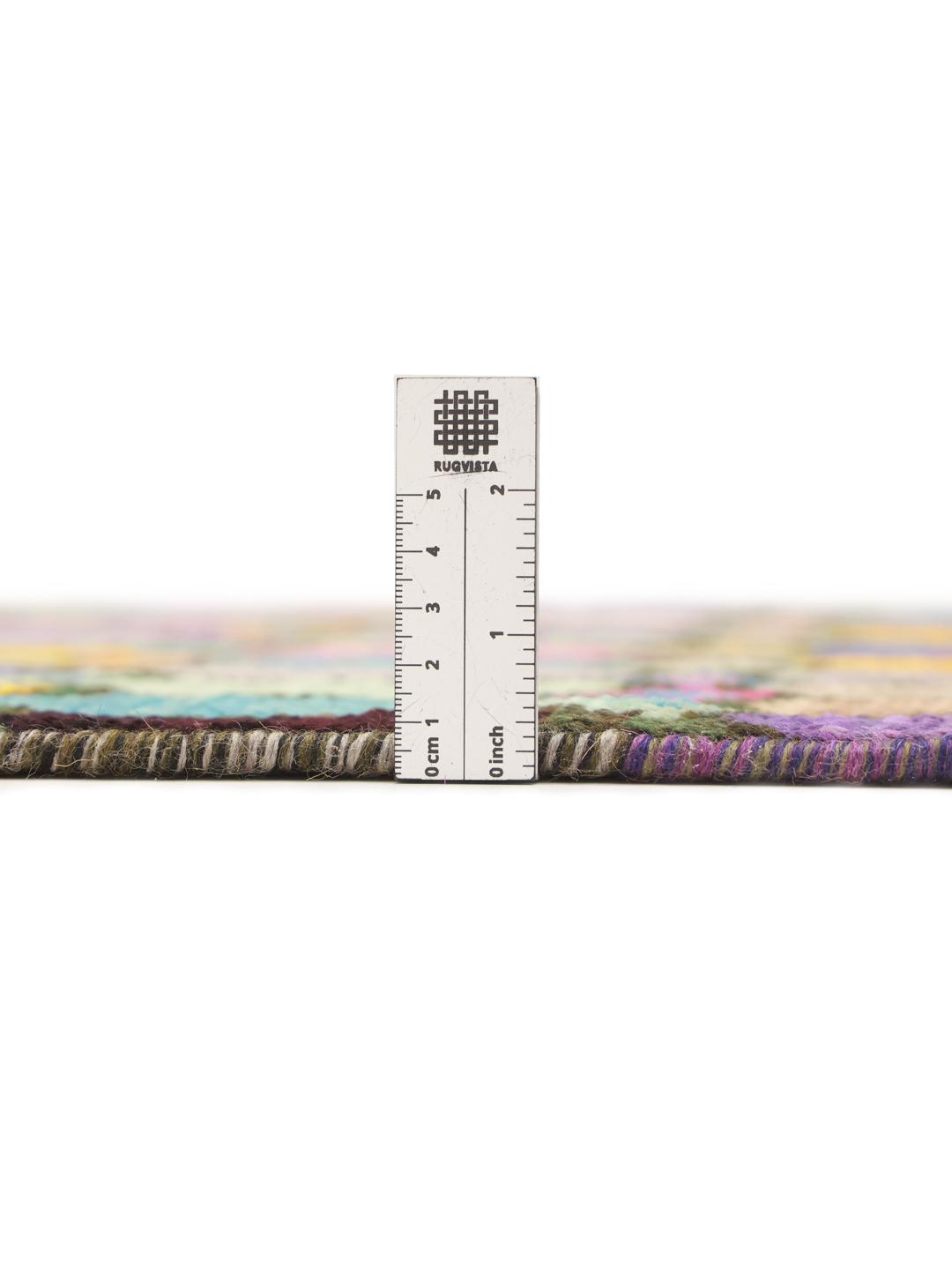 A vibrant rectangular Berber rug from Afghanistan with a colourful geometric pattern.