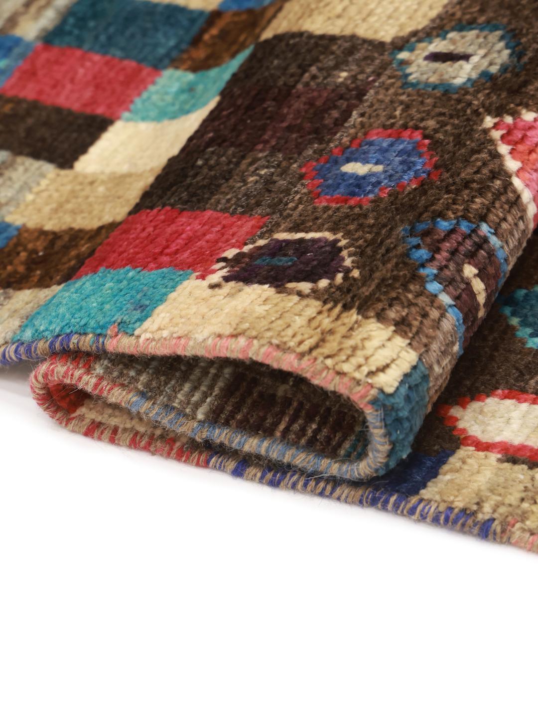Un tapis de couloir vibrant du Moyen-Orient présentant un motif de blocs géométriques colorés et une section marron avec des motifs en losange.