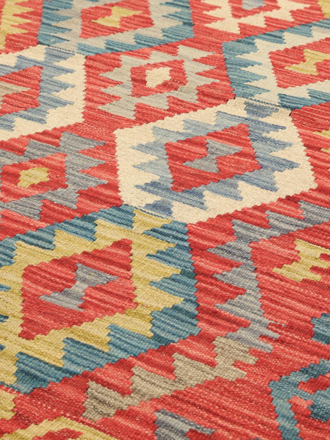 Hand-woven Afghan runner with a red, blue, and green geometric diamond pattern