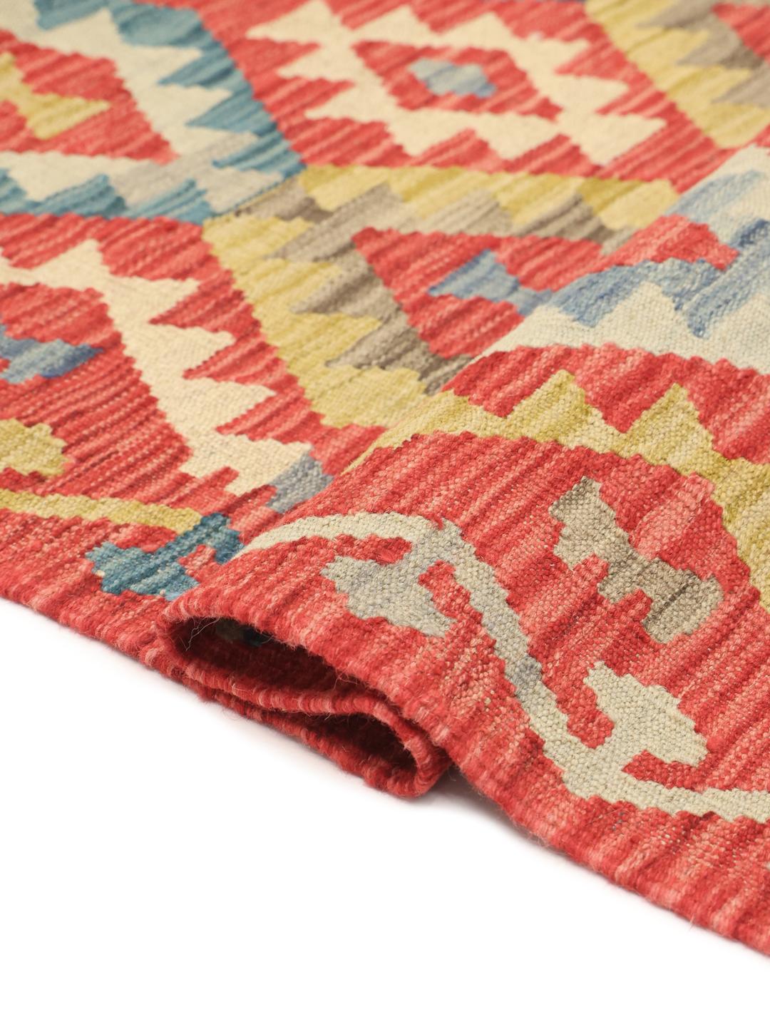 Hand-woven Afghan runner with a red, blue, and green geometric diamond pattern