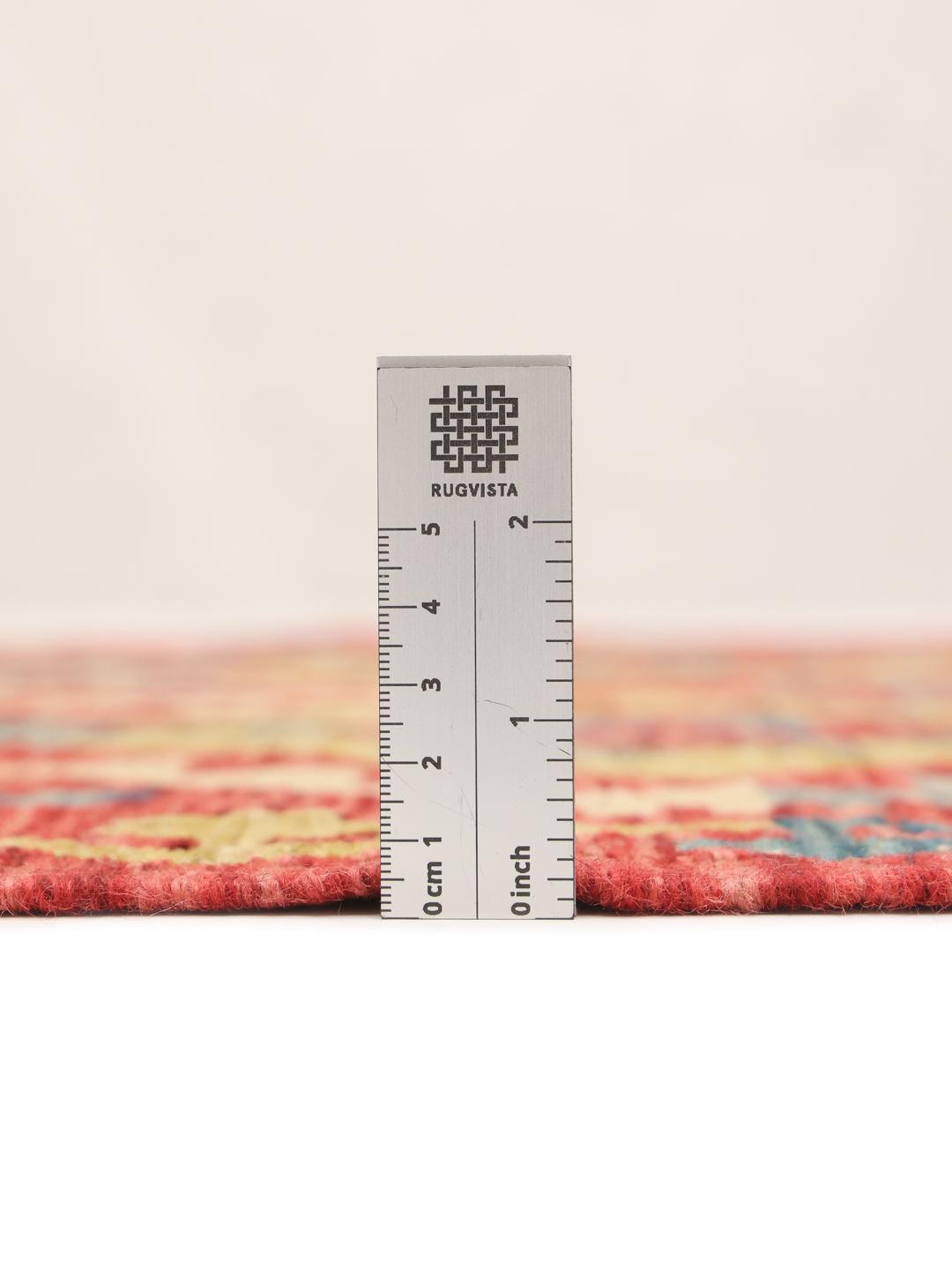 Hand-woven Afghan runner with a red, blue, and green geometric diamond pattern