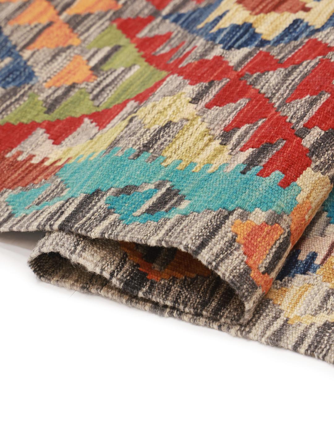 Hand-woven Afghan Kelim rug with a vibrant multicolor geometric pattern