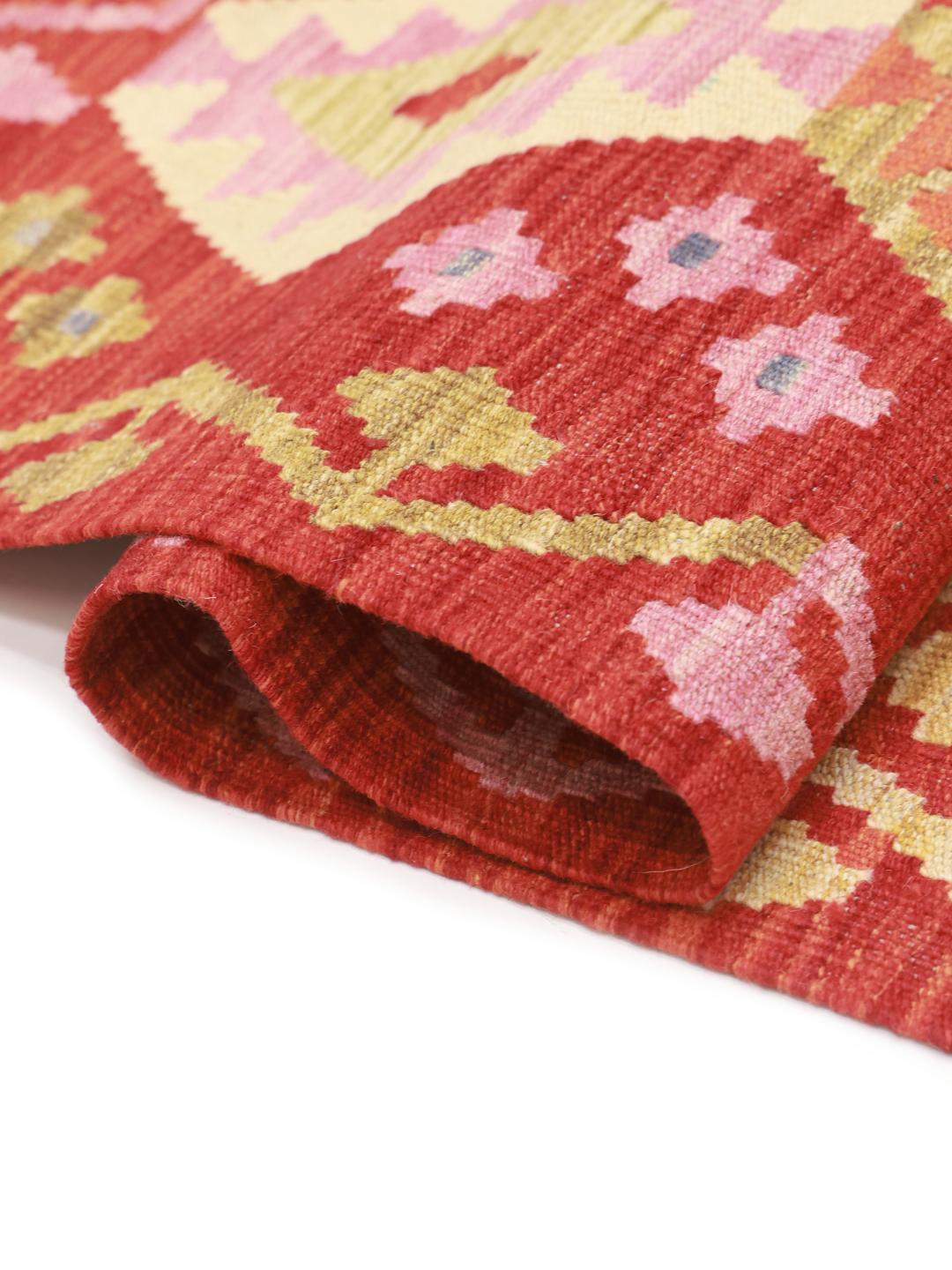 Hand-woven Afghan Kelim rug with red field and geometric diamond patterns