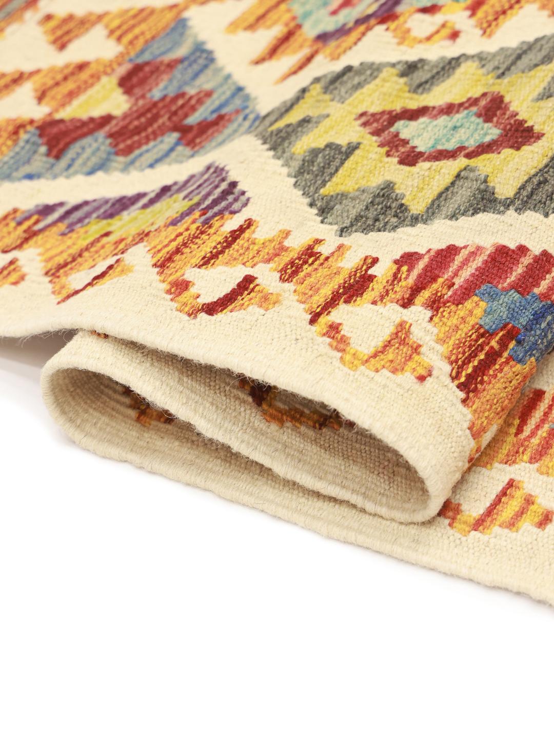 Hand-woven Afghan Kelim rug featuring a colourful geometric diamond pattern in multicolor tones.