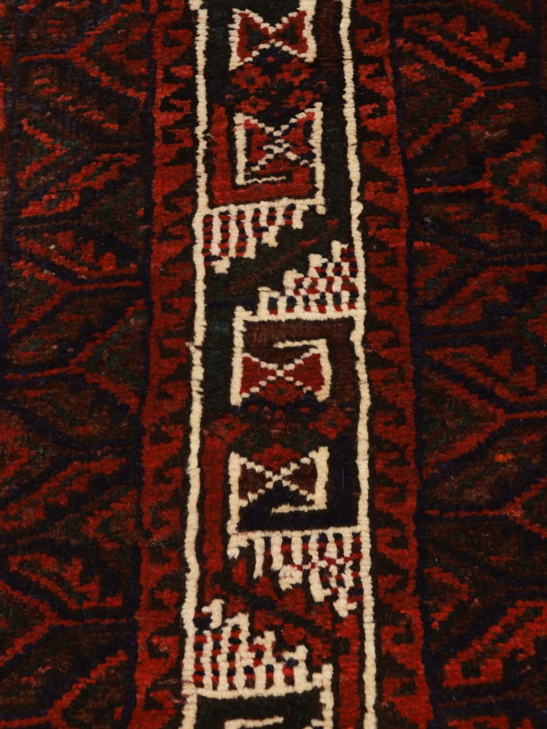 Hand-knotted Shiraz rug from the Middle East featuring a dark-red field with geometric medallions