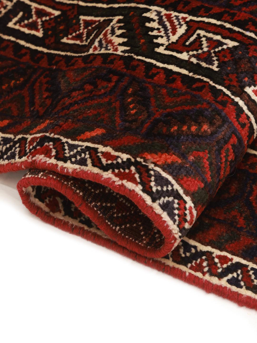 Hand-knotted Shiraz rug from the Middle East featuring a dark-red field with geometric medallions