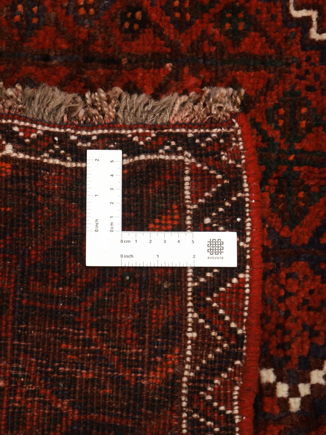 Hand-knotted Shiraz rug from the Middle East featuring a dark-red field with geometric medallions