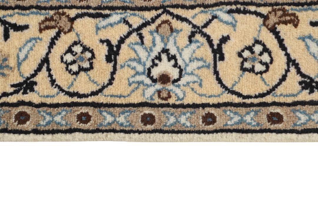 Hand-knotted Nain rug from the Middle East with a beige and blue floral pattern.