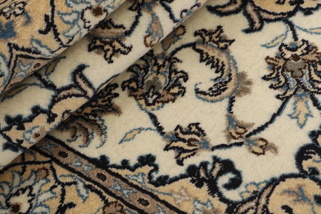 Hand-knotted Nain rug from the Middle East with a beige and blue floral pattern.