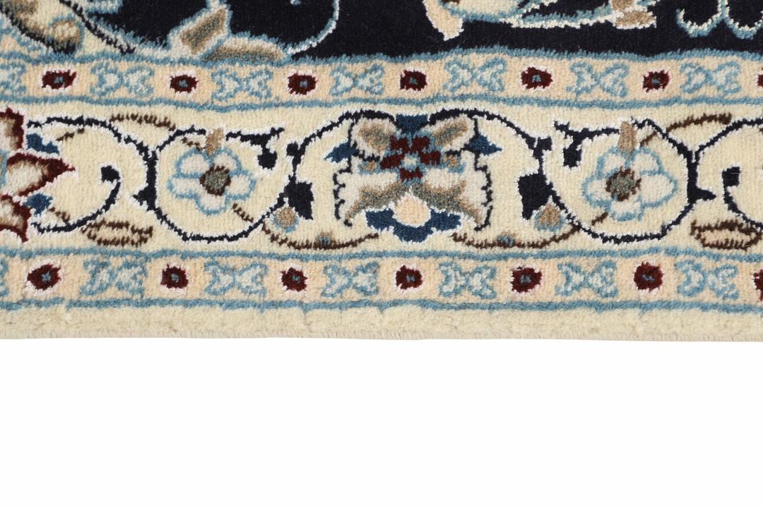 Hand-knotted Nain rug from the Middle East featuring a black and beige floral medallion design.