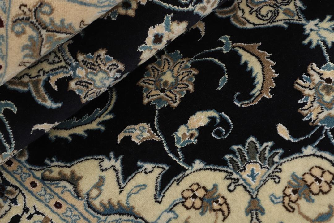 Hand-knotted Nain rug from the Middle East featuring a black and beige floral medallion design.
