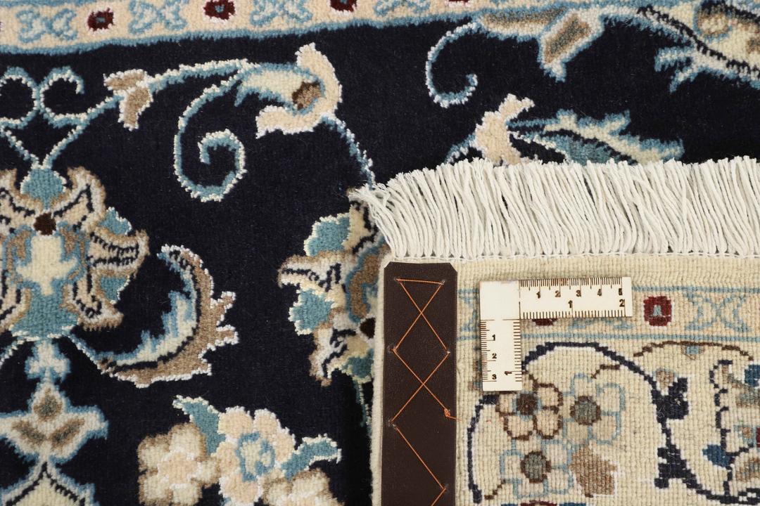Hand-knotted Nain rug from the Middle East featuring a black and beige floral medallion design.