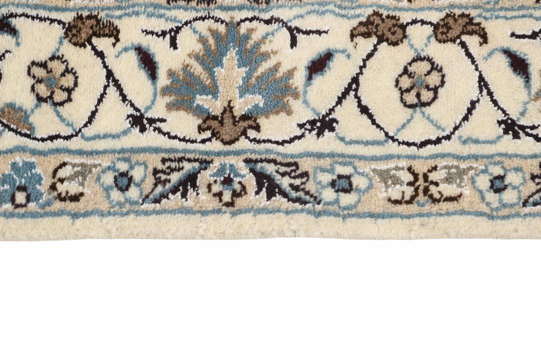 A sophisticated hand-knotted Nain rug from the Middle East in elegant beige tones.