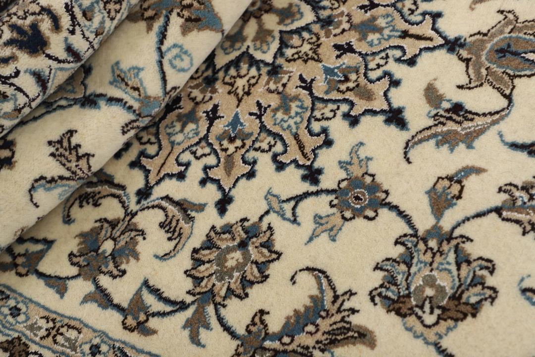 A sophisticated hand-knotted Nain rug from the Middle East in elegant beige tones.