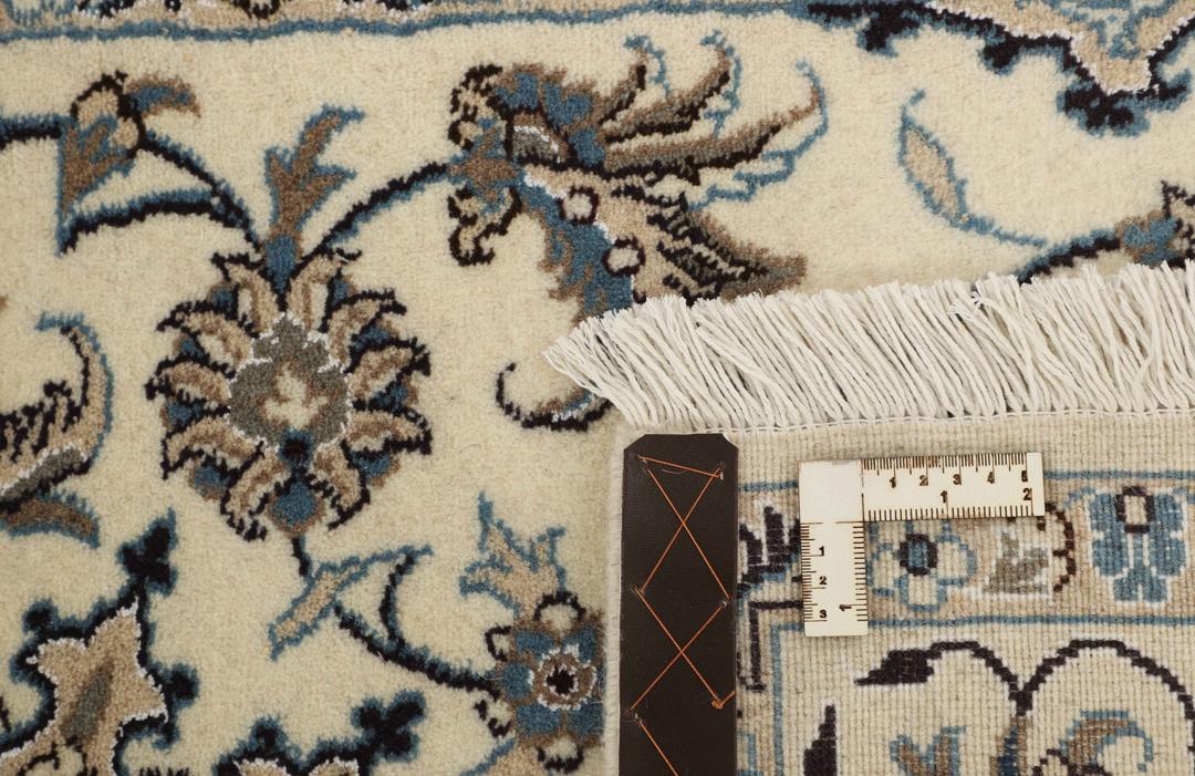 A sophisticated hand-knotted Nain rug from the Middle East in elegant beige tones.