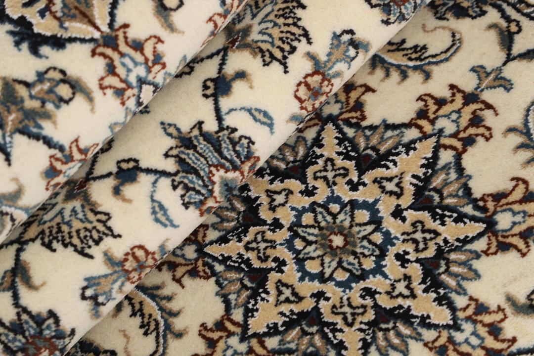Hand-knotted Nain runner with a beige field and floral motifs in blue and earth tones