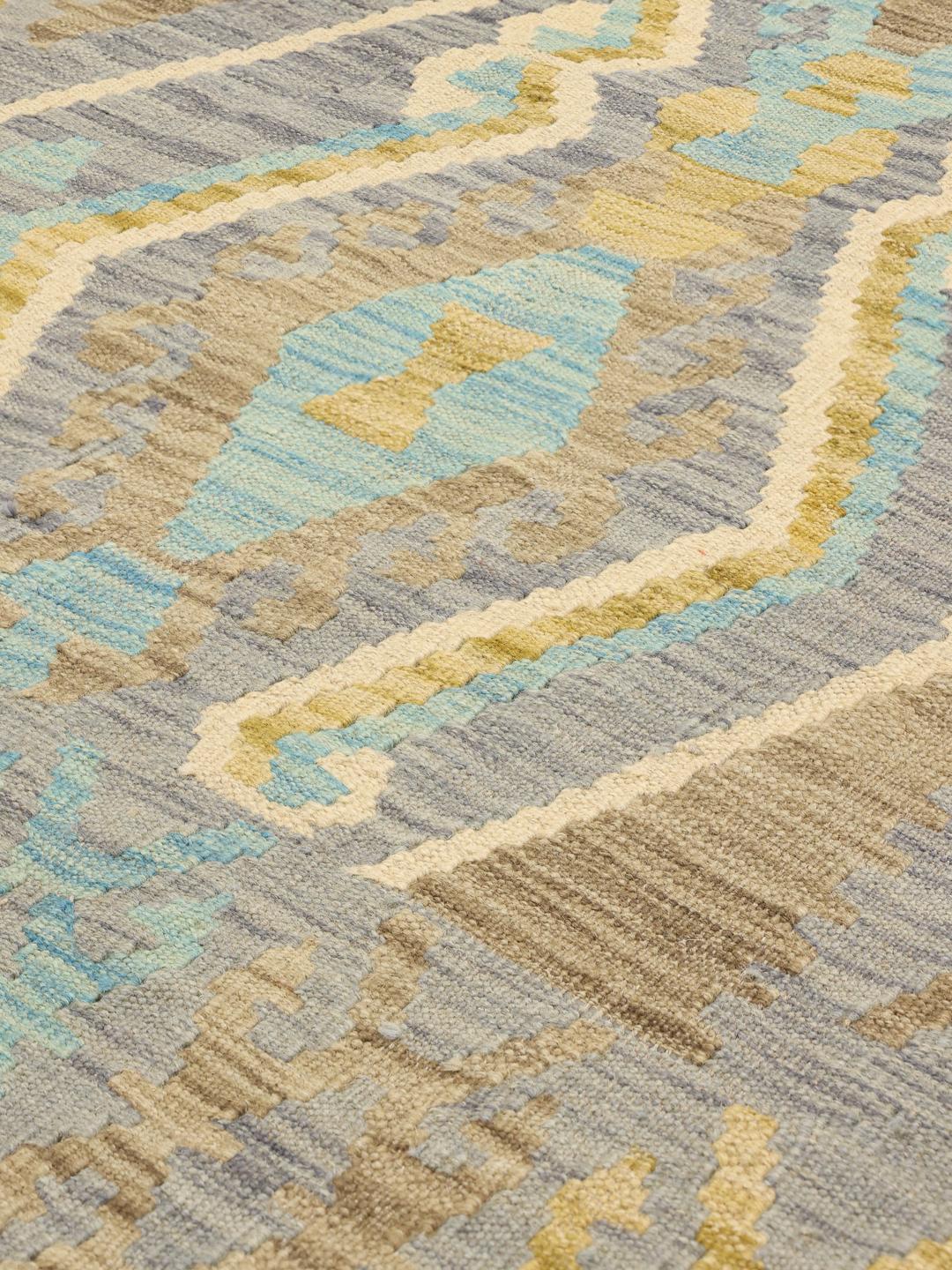 Hand-woven Afghan Kelim rug featuring geometric motifs in shades of blue and brown