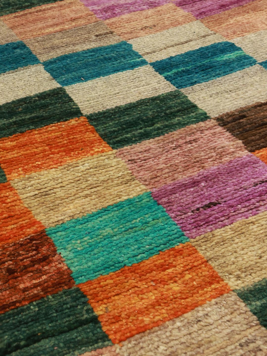 A vibrant multicoloured hand-knotted runner from Afghanistan with a geometric block pattern.