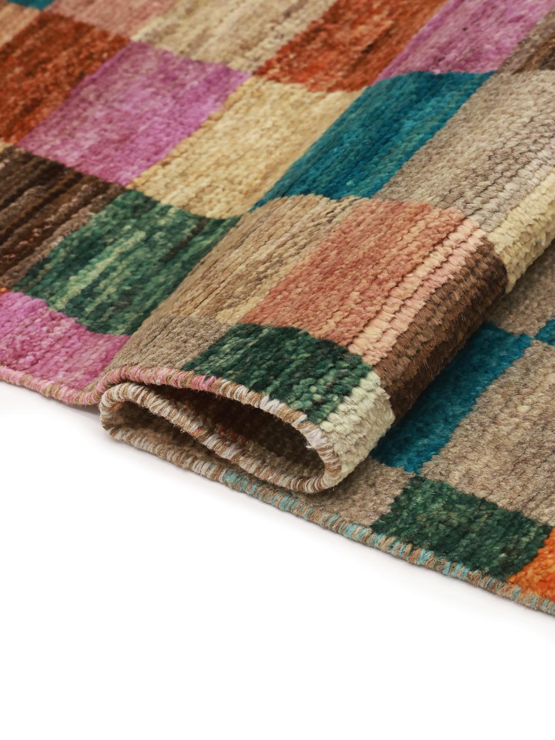 A vibrant multicoloured hand-knotted runner from Afghanistan with a geometric block pattern.