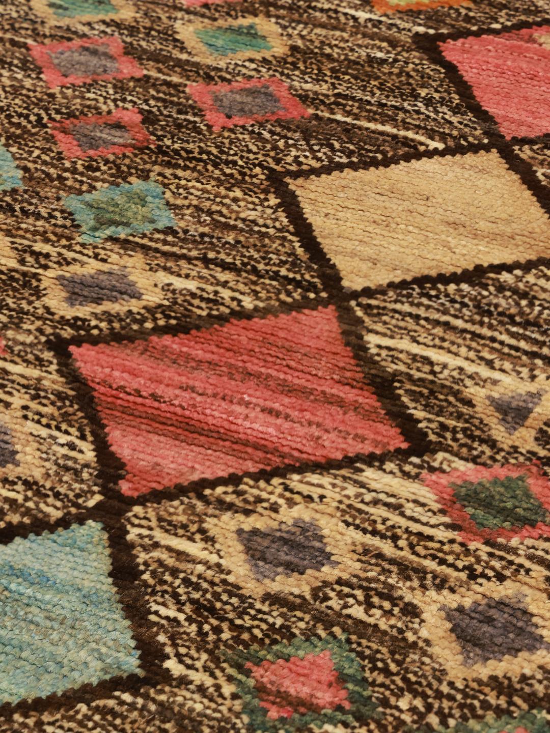 Hand-knotted Afghan Berber rug with a multicolor diamond pattern on a dark background.
