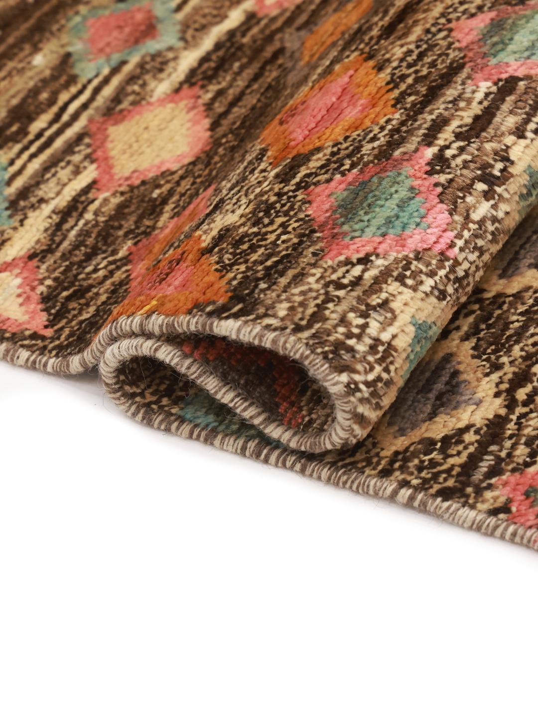 Hand-knotted Afghan Berber rug with a multicolor diamond pattern on a dark background.