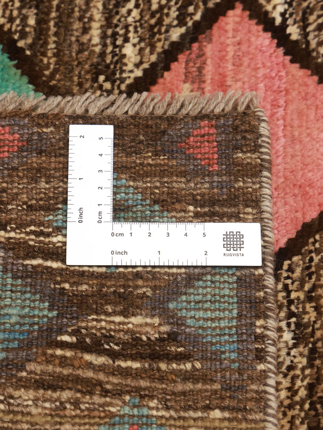 Hand-knotted Afghan Berber rug with a multicolor diamond pattern on a dark background.