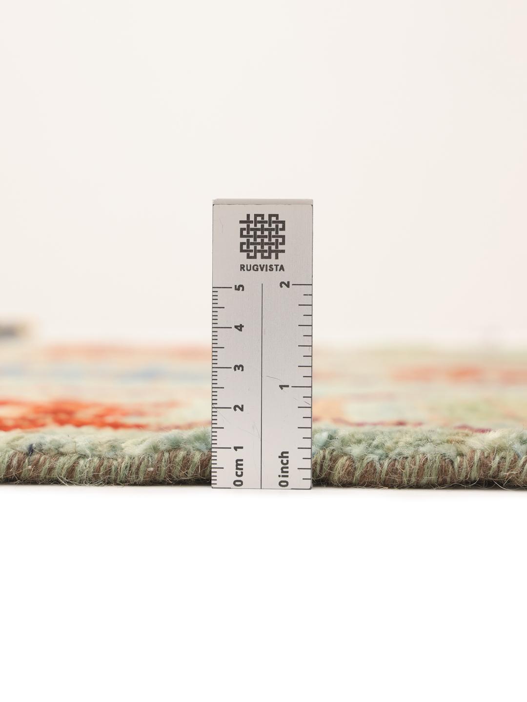 A hand-knotted Afghan runner with a vibrant geometric pattern on a light blue background.