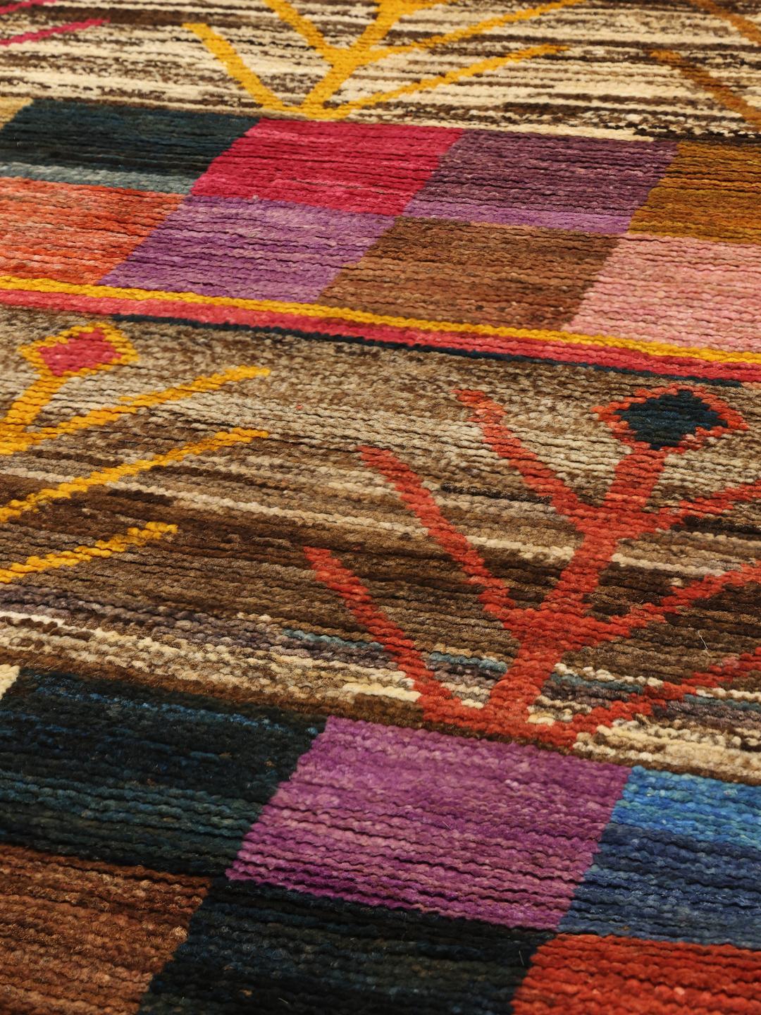 Hand-knotted Afghan runner with a vibrant multicolor geometric and tree-inspired pattern