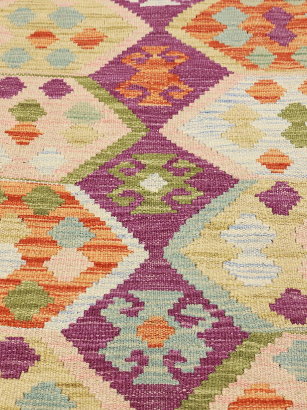 Hand-woven Afghan Kelim rug featuring a vibrant multicolor geometric pattern
