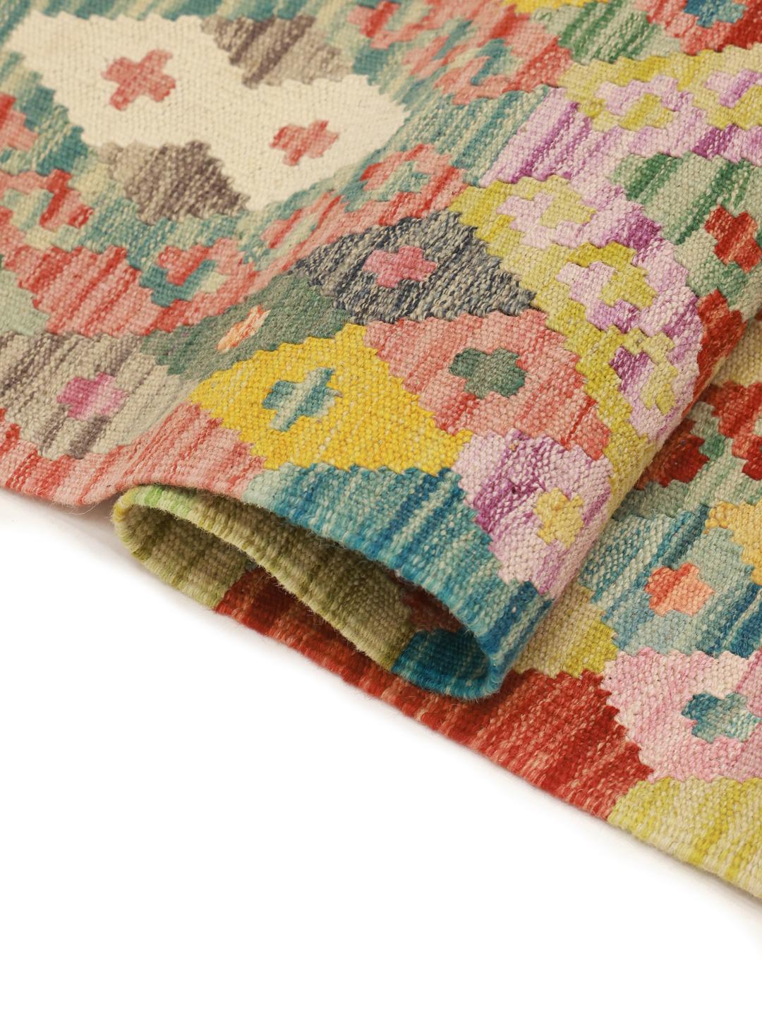 A hand-woven, multicolored Afghan Kelim rug with intricate geometric diamond patterns.