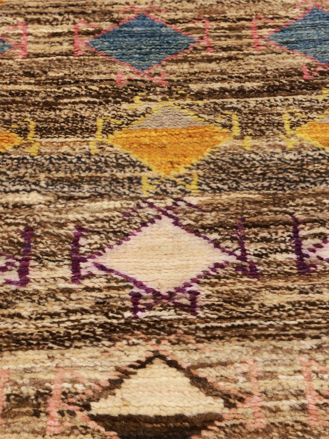 Hand-knotted Berber rug from Afghanistan with a multicolour diamond pattern on a brown background.