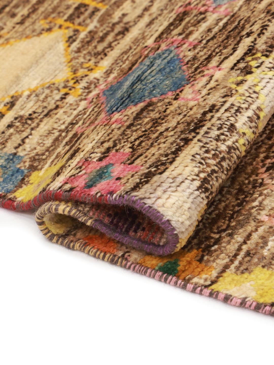 Hand-knotted Berber rug from Afghanistan with a multicolour diamond pattern on a brown background.