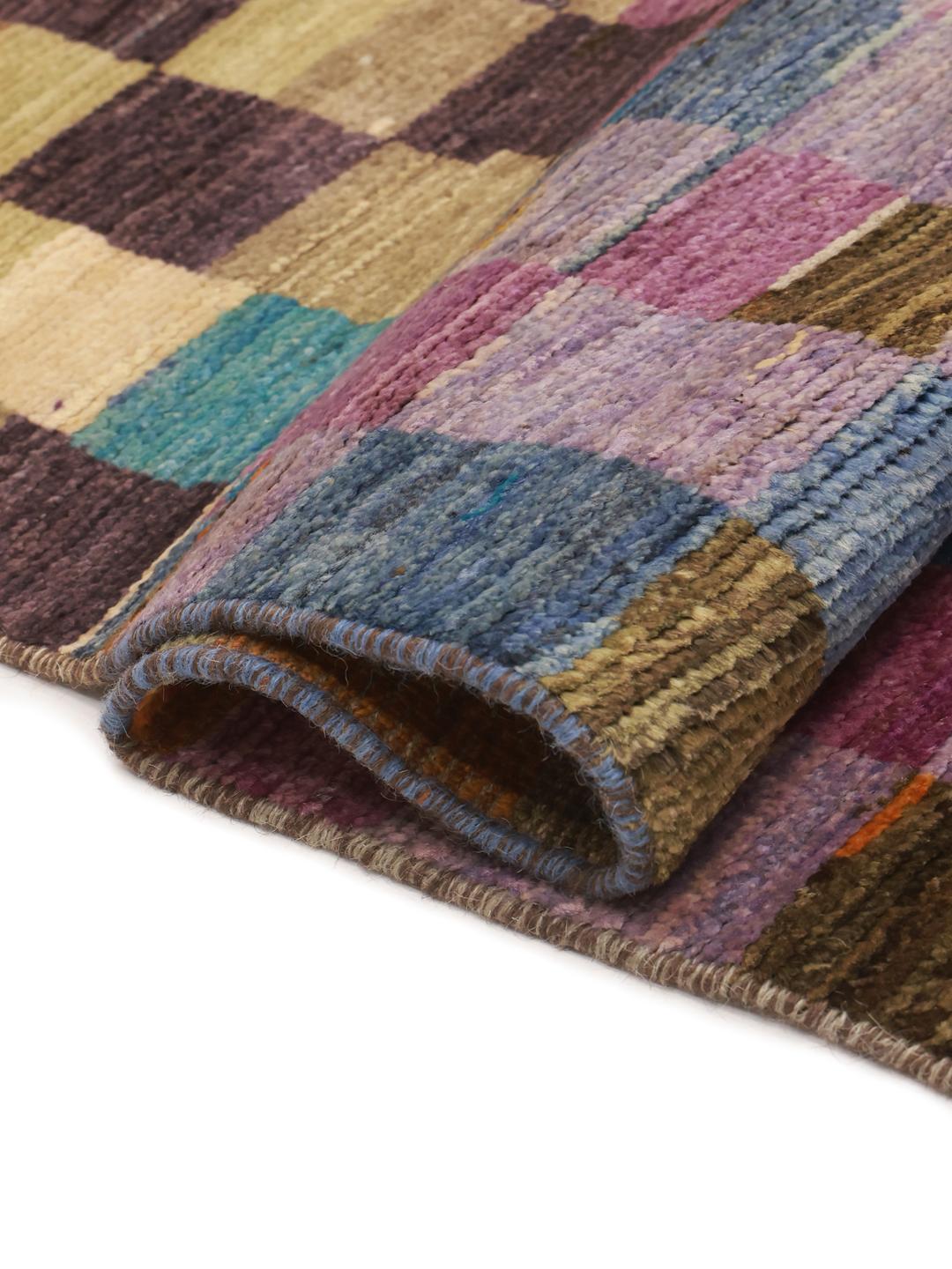 A vibrant, checkered hand-knotted wool runner rug from the Middle East in multicolor tones.