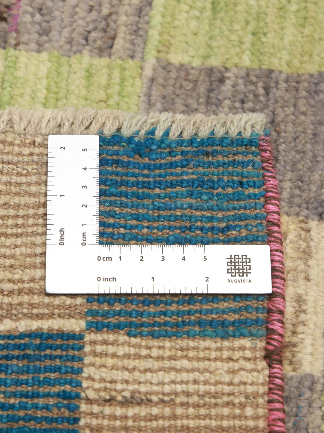 A vibrant, checkered hand-knotted wool runner rug from the Middle East in multicolor tones.