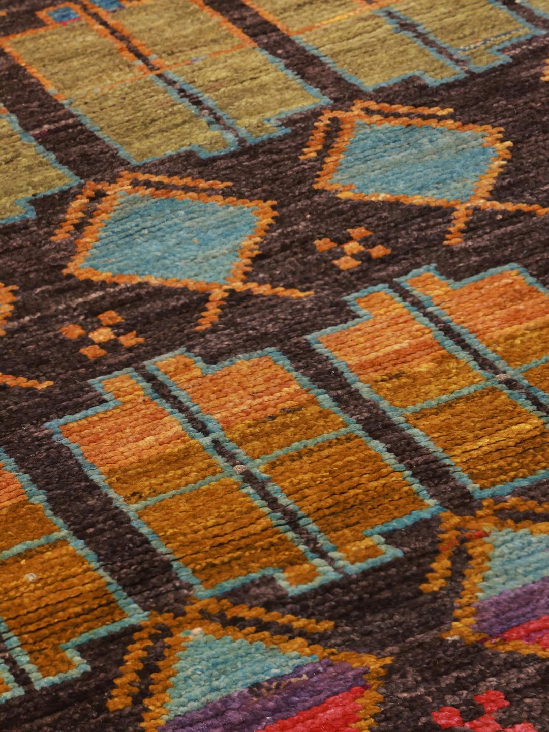 Hand-knotted Afghan runner rug with a multicolor geometric pattern on a dark background