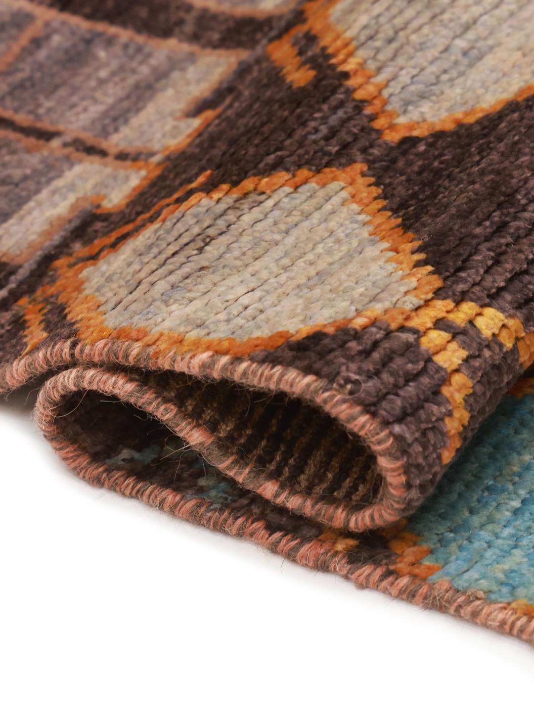 Hand-knotted Afghan runner rug with a multicolor geometric pattern on a dark background