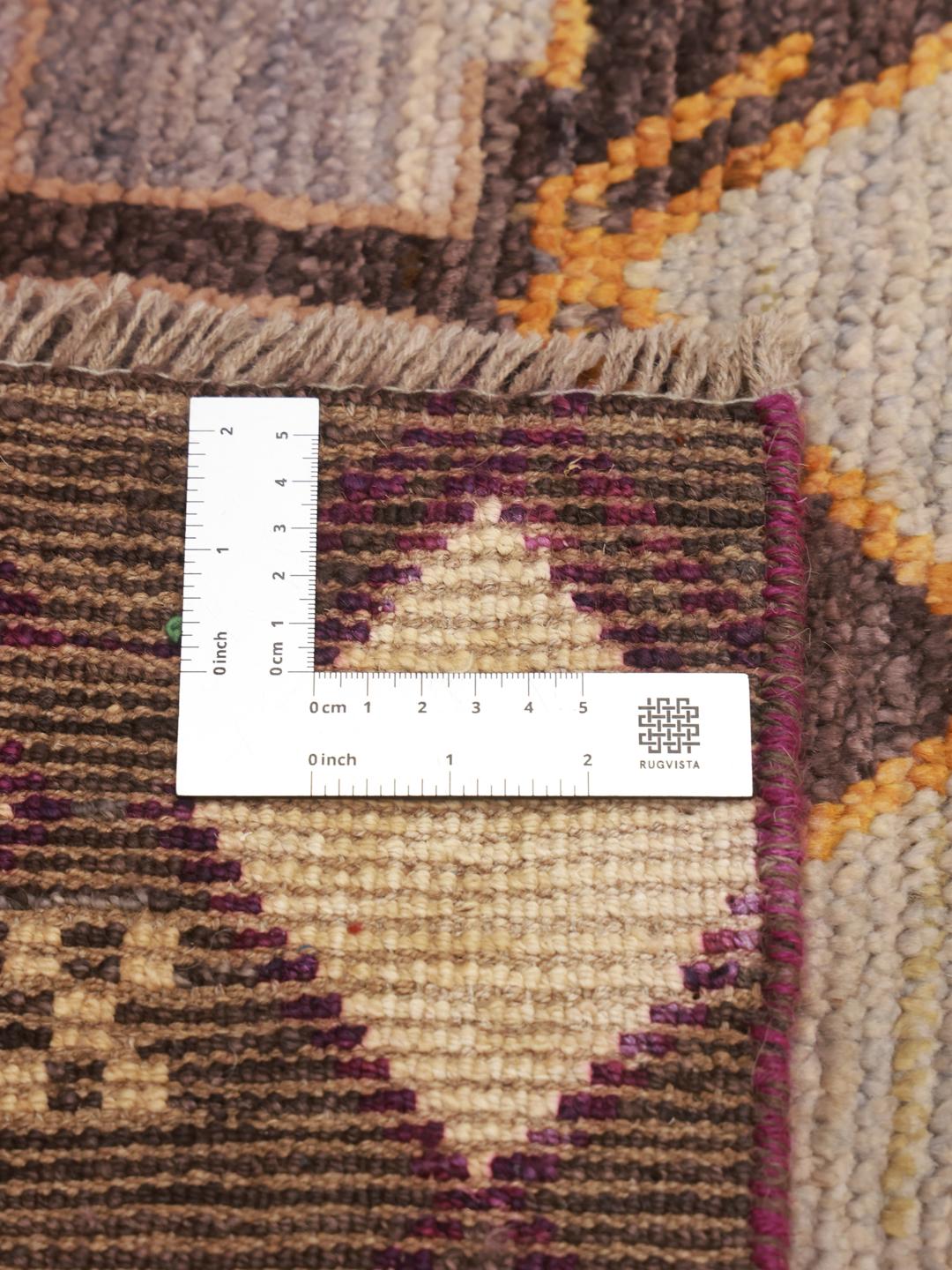 Hand-knotted Afghan runner rug with a multicolor geometric pattern on a dark background