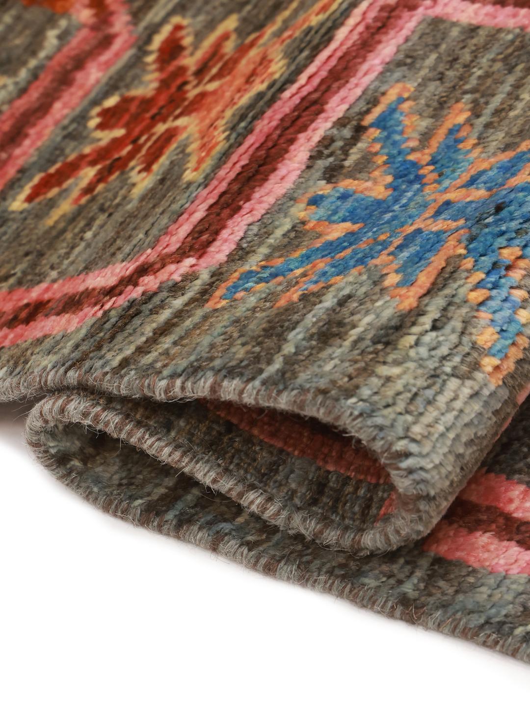 Hand-knotted Middle Eastern runner with a colourful pattern on a grey background